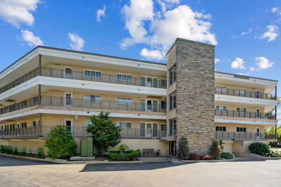 Front view of a multi-story building with brick and stone exterior.