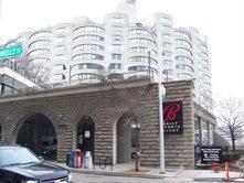 Front view of a multi-story residential building with arched lower structure.