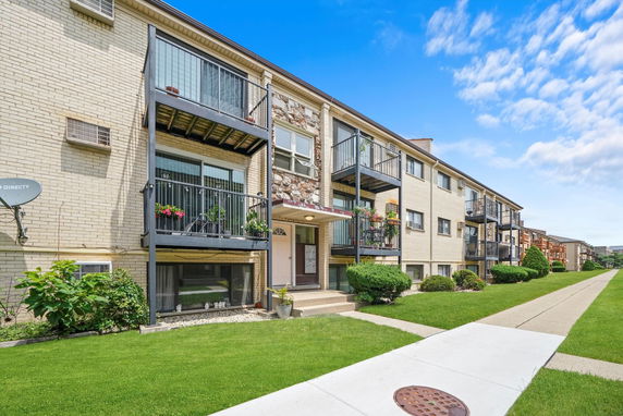 Front view of a two-story apartment building with balconies.