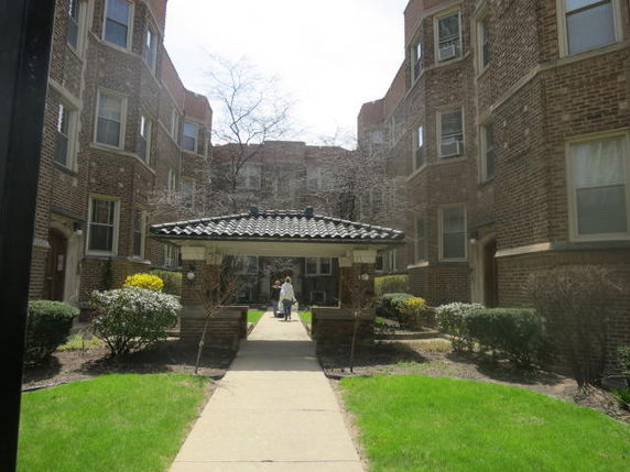 Front view of a multi-story brick building with a central entrance.