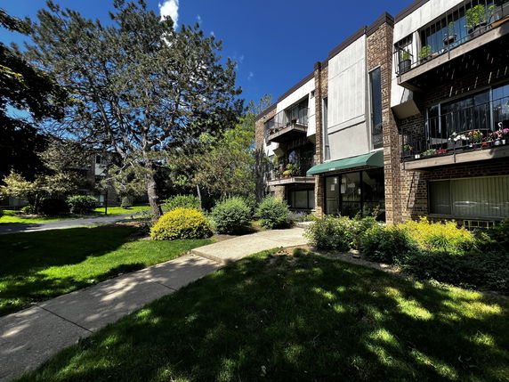 Front view of a multi-story apartment building with balconies.