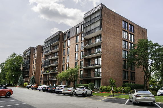 Front view of a multi-story apartment building with balconies.