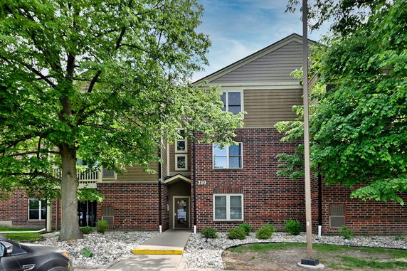 Front view of a multi-story building with a brick facade.