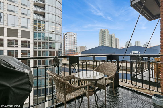 Balcony view of cityscape with high-rise buildings visible.