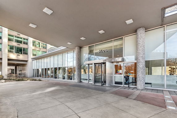 Front view of a commercial building with glass entrance and overhang.