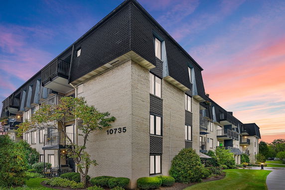 Front view of a multi-story building with balconies and number 10735 visible on the wall.