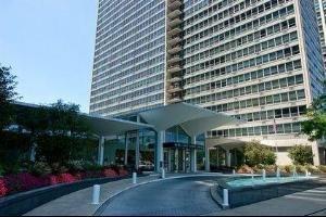 Front view of a high-rise building with a covered entrance.