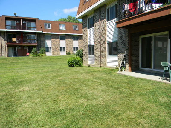 Front view of a multi-story apartment building with balconies.