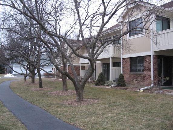 Front view of a two-story building with balconies and a pathway.
