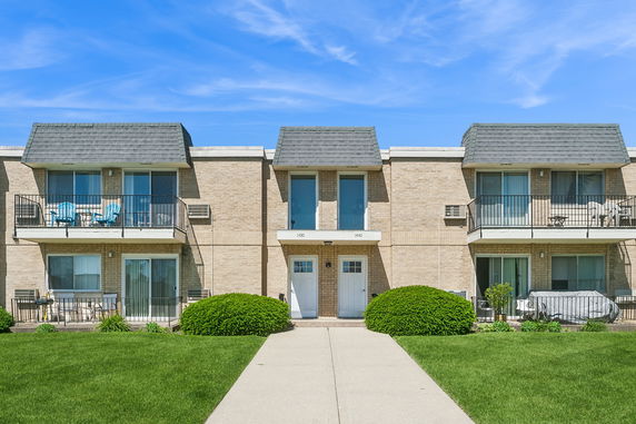 Front view of a two-story apartment building with balconies.