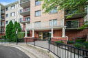 Front view of a multi-story apartment building with balconies.