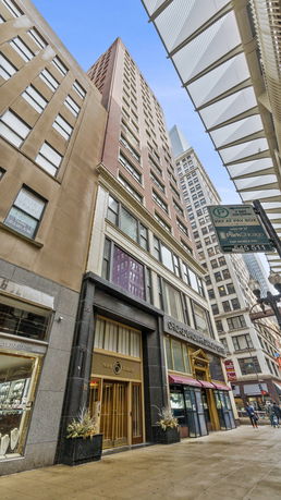 Front view of a tall commercial building with multiple stories.