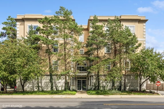 Front view of a multi-story building with trees along the facade.