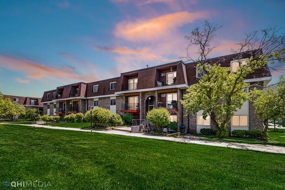Front view of a multi-story residential building with balconies.