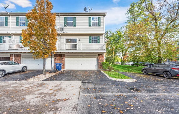 Front view of a multi-story townhouse with attached garage.