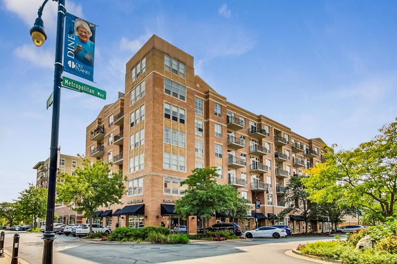 Front view of a multi-story commercial and residential building on Metropolitan Way.