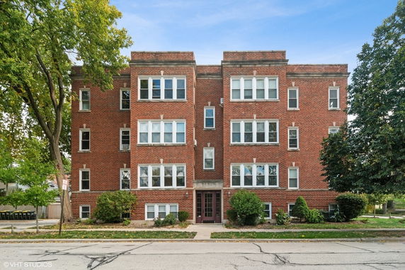 Front view of a multi-story brick apartment building.
