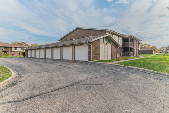 Front view of a residential building with multiple garage doors.