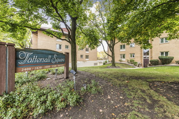 Front view of a multi-story apartment building with a sign for Tattersall Square.