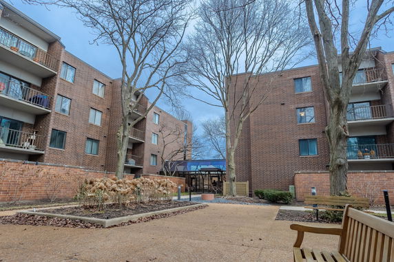 Exterior view of a multi-story brick apartment building with balconies.
