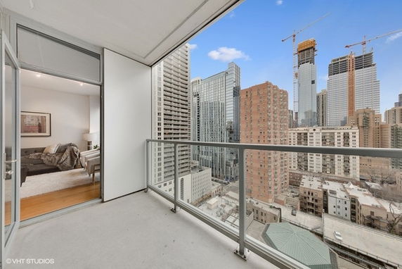 High-rise building balcony with a cityscape view.