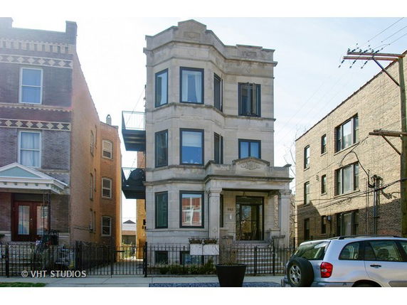 Front view of a multi-story residential building with a classic architectural style.