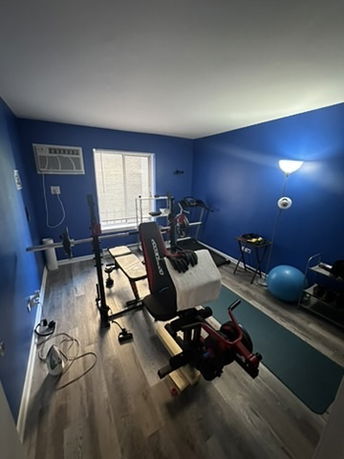 Room with gym equipment for exercise and fitness.