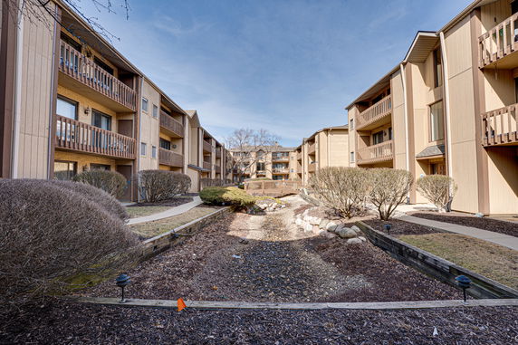 Front view of a multi-story apartment complex with balconies.