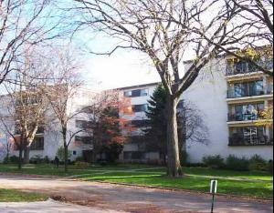 Front view of a multi-story apartment building with balconies.