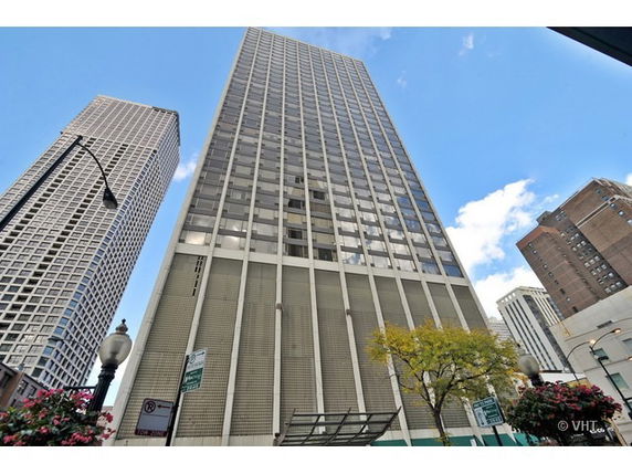 Front view of a high-rise building with glass facade.