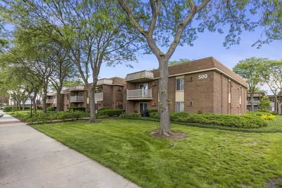 Front view of a two-story brick apartment building.