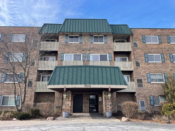 Front view of a multi-story building with balconies.