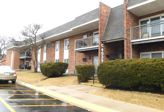 Front view of a two-story brick building with balconies.