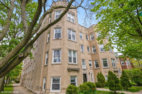 Front view of a multi-story brick apartment building.