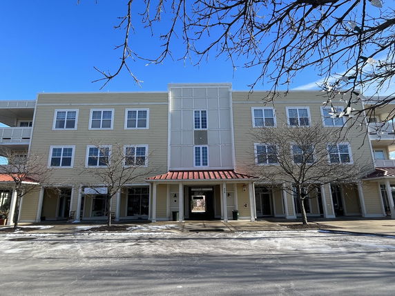 Front view of a three-story building with multiple windows and a central entrance.