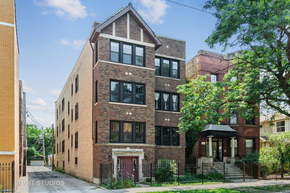 Front view of a three-story brick apartment building.