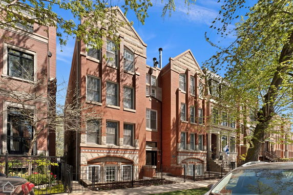 Front view of a multi-story brick apartment building.