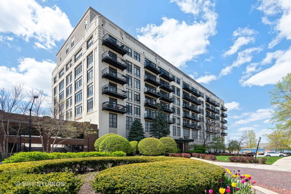 Front view of a multi-story building with balconies.
