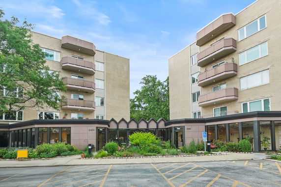 Front view of a multi-story residential building with balconies.