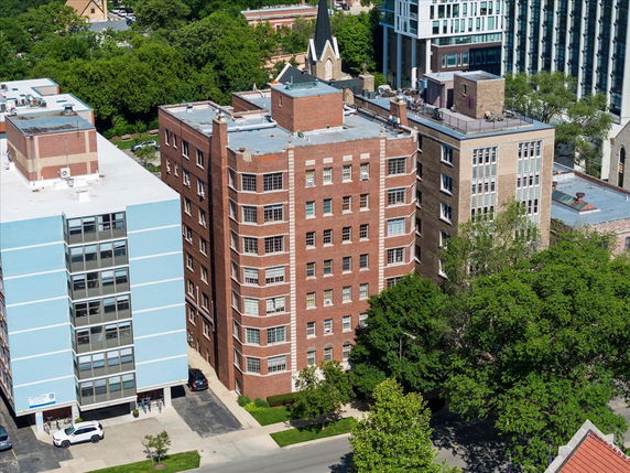 Front view of a multi-story brick apartment building.