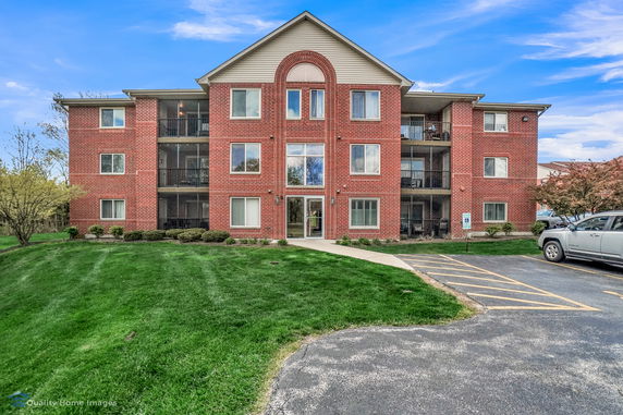 Front view of a three-story brick apartment building.