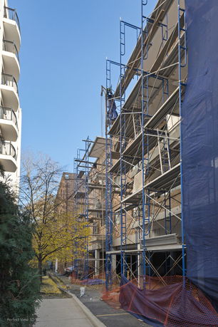 Front view of a building under construction with scaffolding.