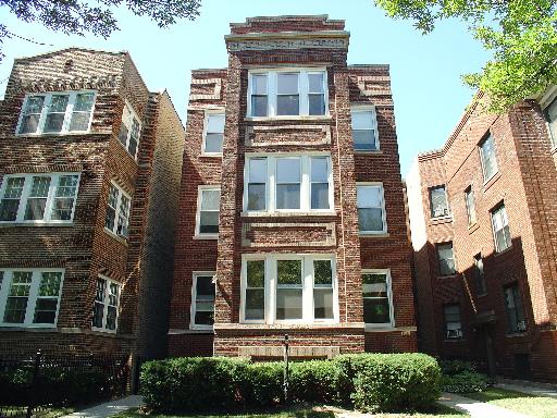Front view of a multi-story brick apartment building.