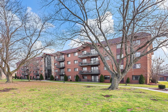 Front view of a multi-story residential building with balconies.