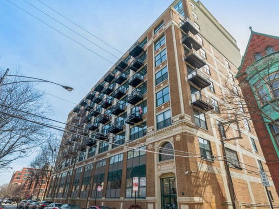 Front view of a multi-story building with balconies.