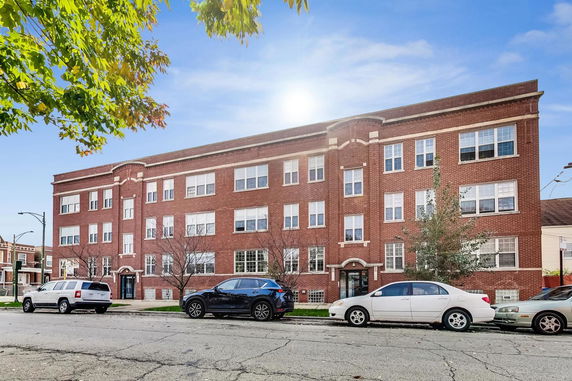 Front view of a multi-story brick apartment building.