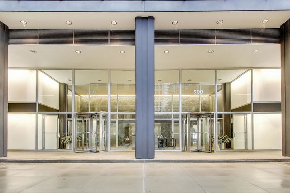 Front view of a modern building with large glass entrance doors.
