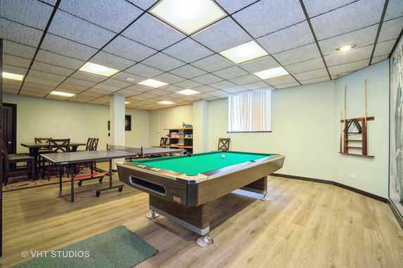 Room with a pool table and table tennis setup