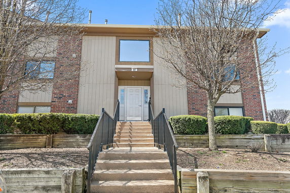 Front view of a two-story brick building with a central entrance.