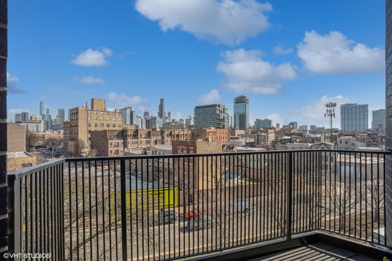 Wide angle view of the city skyline from a balcony.